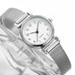 Silver watch with a white face on a textured surface